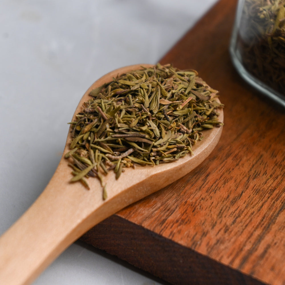Positively Botanicals Loose Leaf Thyme on a wooden spoon.