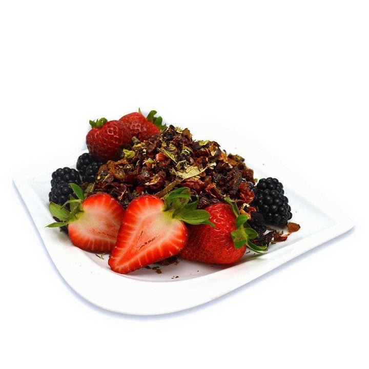 Very Berry Citrus loose leaf herbal tea blend served with fresh strawberries and blackberries, highlighting fruity, tart notes.